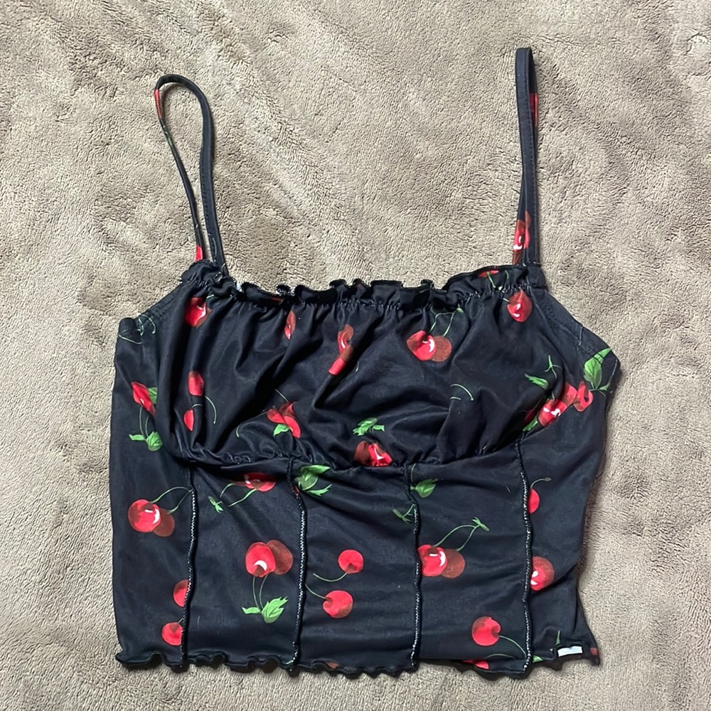 Super cute tank top with cherries on the top ruffled top area